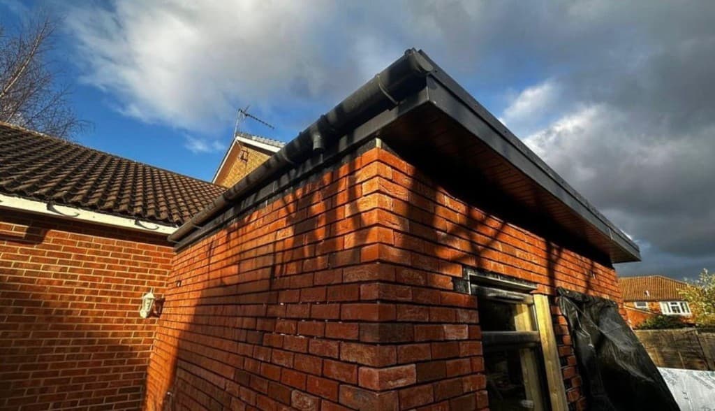 Brick slip cladding being applied to an extension corner