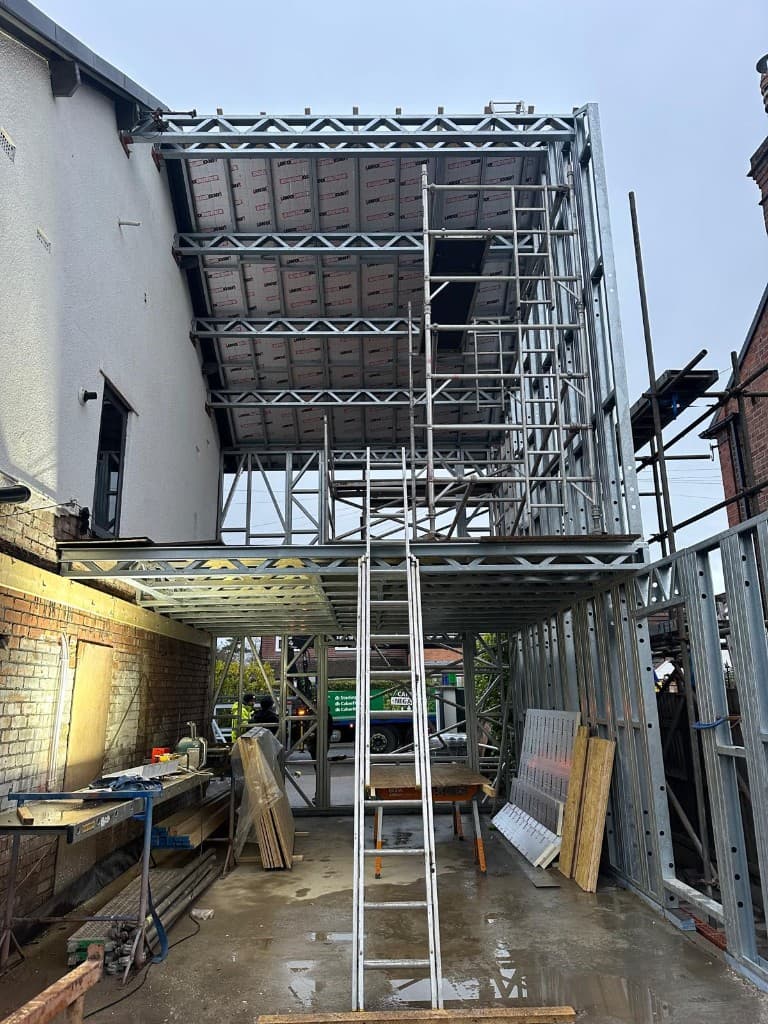 Rendered home extension with blue protective film on new windows