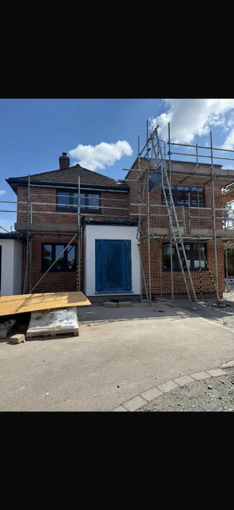 Rear garden steel frame extension attached to a brick house